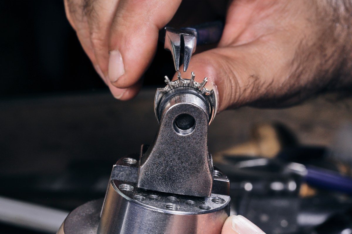 Jeweler working on a diamond pendant held in a bench vise